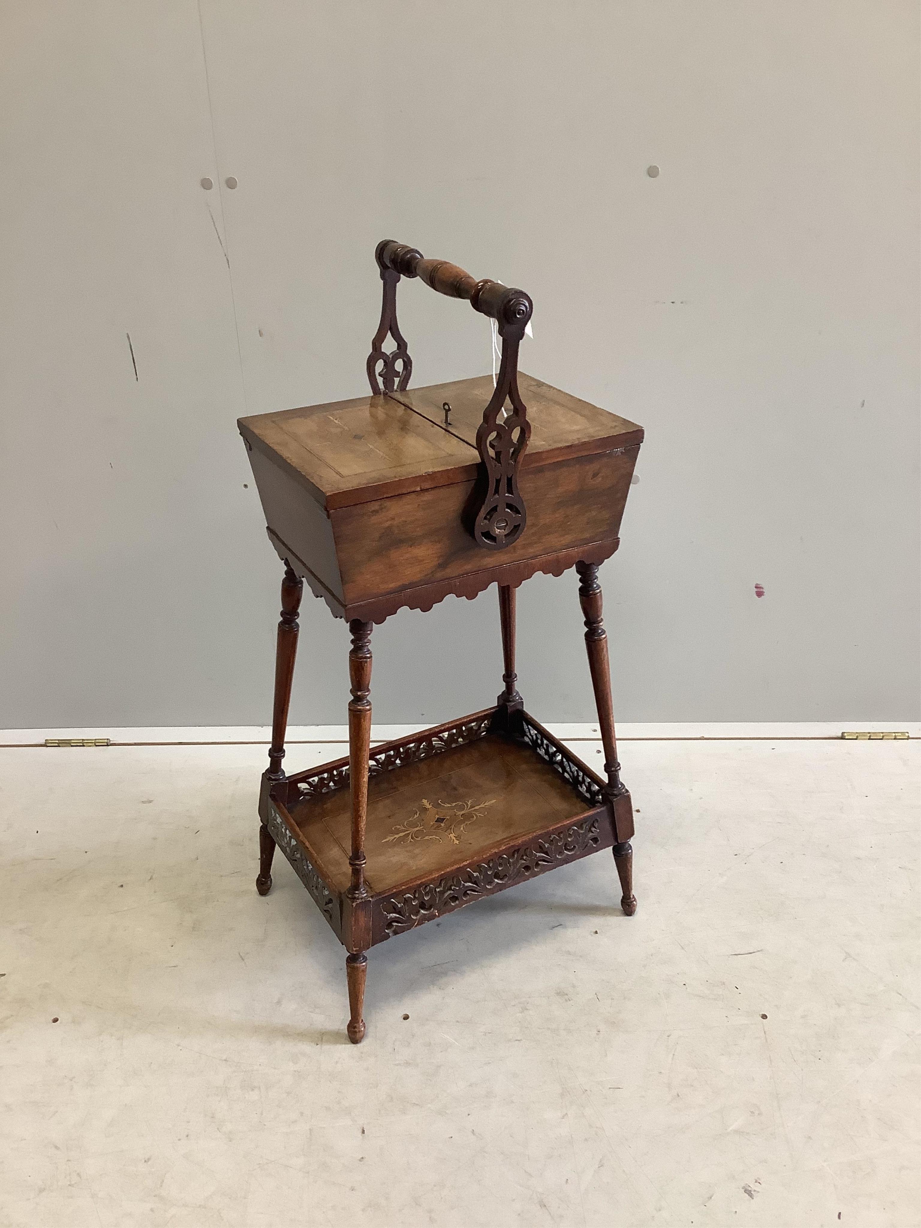 A 19th century Continental marquetry inlaid walnut sewing box having twin flap top, galleried undertier and swing handle, width 40cm, depth 30cm, height 86cm. Condition - fair